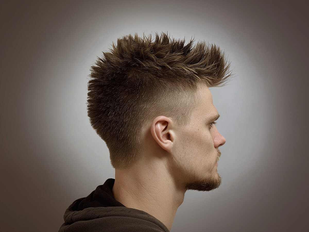 Side profile of a textured burst fade haircut