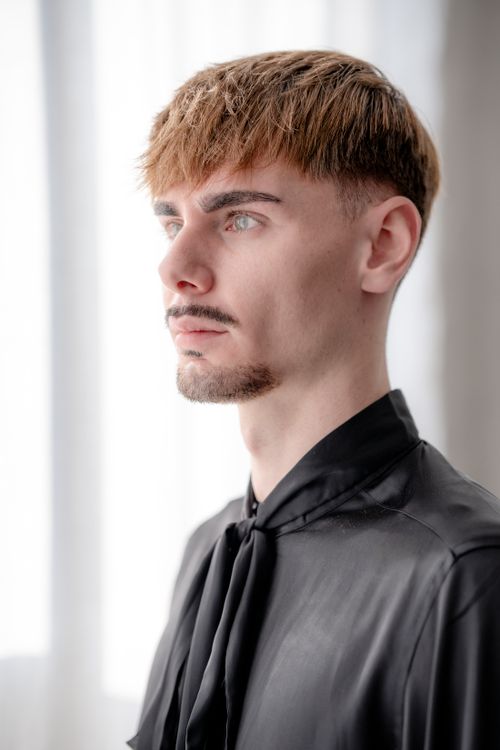 Professional man in a black shirt with a polished short haircut