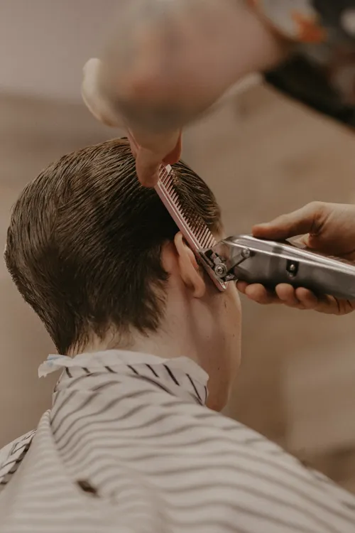 Close salon view of a barber refining a textured crop and short sides